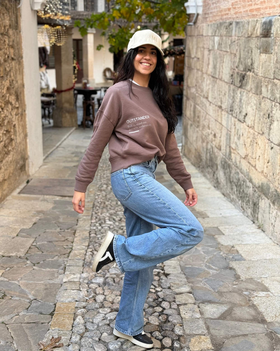 Alexandra caminando con la Sudadera Outstander Mujer Moca, estilo casual de medium fit y moda sostenible hecha con algodón orgánico